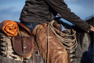 Saddle with adult saddle slicker